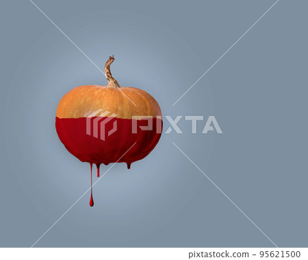 Decoration for Halloween. An orange pumpkin with paint running down it. minimalistic concept on blue background Decoration for Halloween. An orange pumpkin with paint running down it. minimalistic concept on blue background 95621500