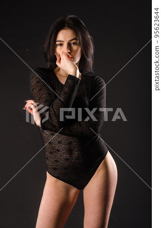 Young beautiful girl naked isolated on a black background Young beautiful girl naked isolated on a black background 95623644