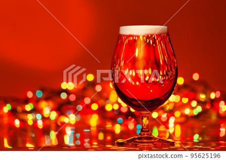 Tulip glass of beer with christmas lights 95625196