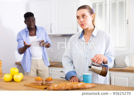 Domestic quarrel of husband and wife in kitchen during breakfast 95625270