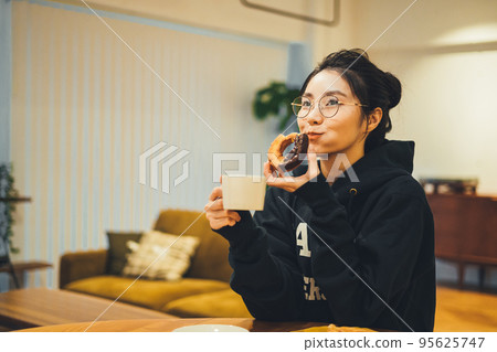 A woman eating a snack 95625747