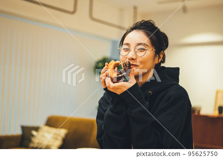 A woman eating a snack 95625750