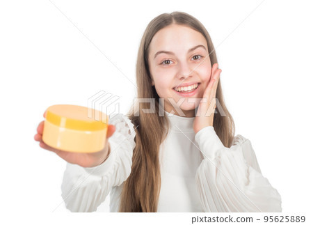 happy child presenting beauty cosmetic product of facial skin cream selective focus, skin 95625889