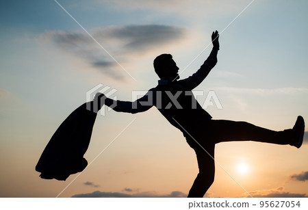 Live your life. personal achievement goal. man silhouette jump on sky background. confident businessman running. daily motivation. enjoying life and nature. business success. freedom Live your life. personal achievement goal. man silhouette jump on sky background. confident businessman running. daily motivation. enjoying life and nature. business success. freedom 95627054