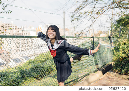 High school girl on her way home after school High school girl on her way home after school 95627420