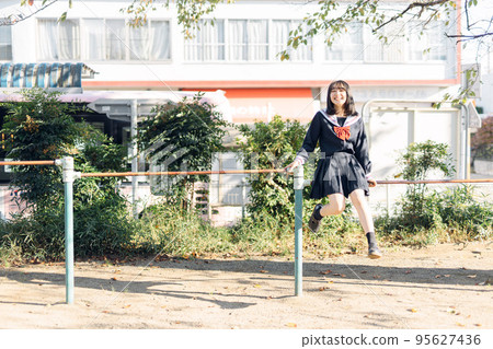 High school girl on her way home after school High school girl on her way home after school 95627436