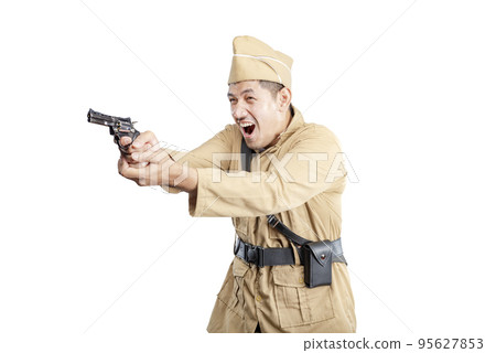 Indonesian freedom fighter standing while holding gun Indonesian freedom fighter standing while holding gun 95627853