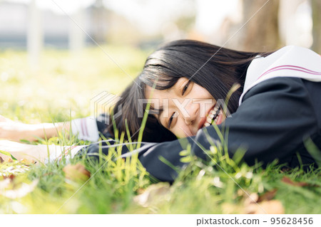 High school girl lying on the lawn High school girl lying on the lawn 95628456
