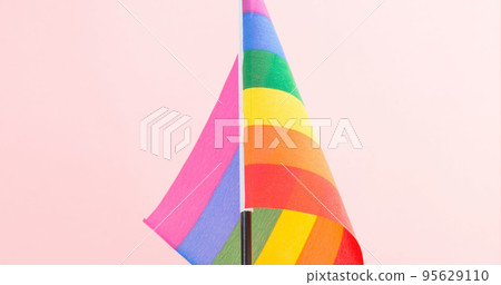 Close-up of rainbow flag isolated against pink background, copy space Close-up of rainbow flag isolated against pink background, copy space 95629110