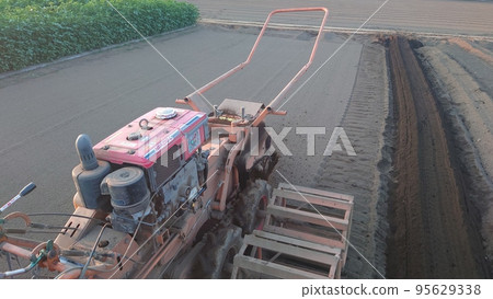 Farm work using a trencher 95629338