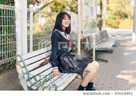 high school girl at the bus stop 95629401