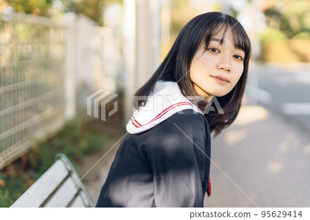 high school girl at the bus stop 95629414
