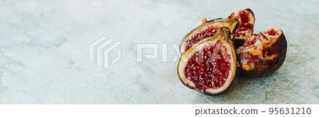 some cut ripe figs on a table, banner format some cut ripe figs on a table, banner format 95631210