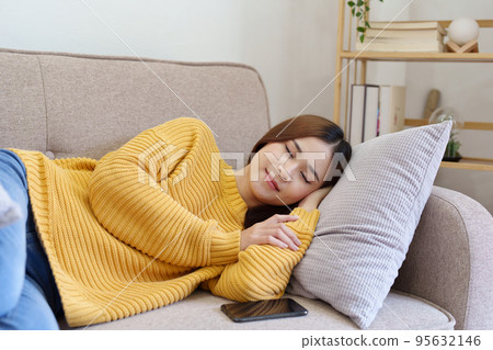woman resting on the sofa at home. 95632146