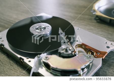 Disassembled computer hard drive. Data hard drive backup disc hdd disk restoration. Disassembled hard drive from the computer, hdd with mirror effect. 95633876