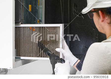 Replacing filter in the central ventilation system. hvac filter replacing home central air system 95633918