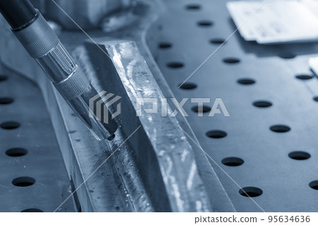 Close up scene the automatic welding robot working with automotive parts assembly processing. Close up scene the automatic welding robot working with automotive parts assembly processing. 95634636