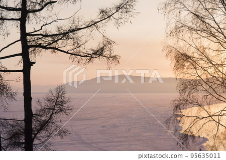 Beautiful sunset on frozen lake Baikal. Winter landscape. Beautiful sunset on frozen lake Baikal. Winter landscape. 95635011