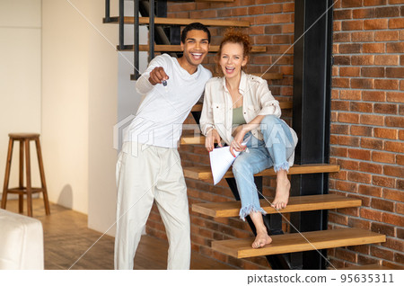 Young people looking happy after signing contract for new apaprtment lease 95635311