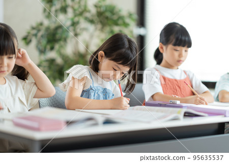 Elementary school students studying at cram school. Elementary school students studying at cram school. 95635537