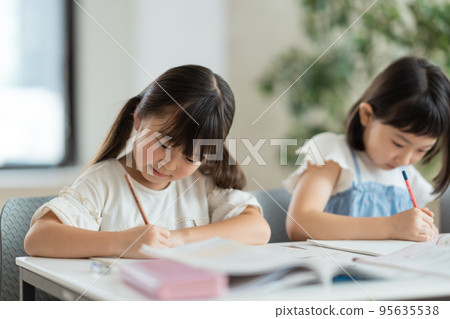 Elementary school students studying at cram school. Elementary school students studying at cram school. 95635538
