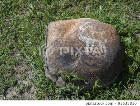 Ancient rock painting (petroglyphs) of animal 2 millenium B.C. in Burana settlement in Kyrgyzstan 95635810