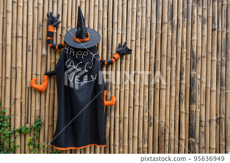 Rear of wizard with black hat and cloak painting Happy Halloween Rear of wizard with black hat and cloak painting Happy Halloween 95636949