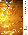 Wave on the beach at sunset 95636953