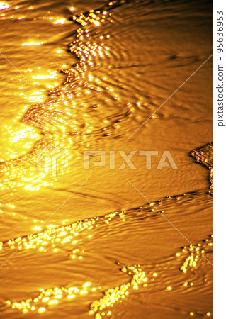 Wave on the beach at sunset 95636953