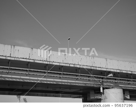Streetlights and signs of deterioration on the highway. Monochrome. Streetlights and signs of deterioration on the highway. Monochrome. 95637196