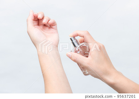 Woman's hand wearing perfume 95637201