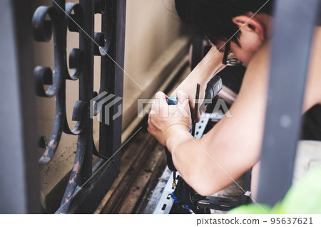 do it yourself concept, Craftsmen use electric drills to assemble old iron parts. Make a shelf on your free weekend. do it yourself concept, Craftsmen use electric drills to assemble old iron parts. Make a shelf on your free weekend. 95637621