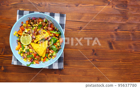 Cowboy caviar, texas caviar corn, beans, tomatoes, avocado, lime Served with nachos chips corn. Copy space Cowboy caviar, texas caviar corn, beans, tomatoes, avocado, lime Served with nachos chips corn. Copy space 95637780