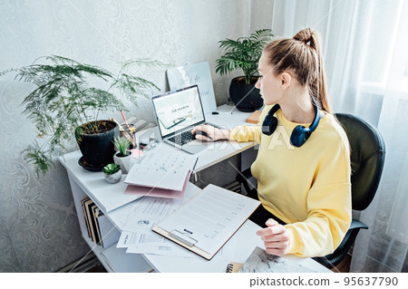 Student Employment Job Search. Young Student woman browsing work opportunities online using job search web sites and applications in home Student Employment Job Search. Young Student woman browsing work opportunities online using job search web sites and applications in home 95637790