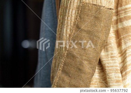 Patch on a man wool sweater. Striving to reduce the amount of waste and reasonable consumption, fashionable needlework. Selective focus 95637792