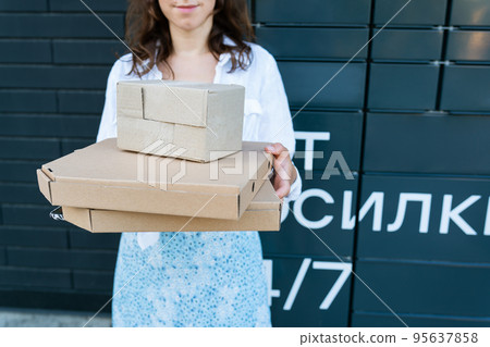 Happy woman holding many different cardboard boxes with online order, satisfied with fast delivery, buying high quality products. 95637858