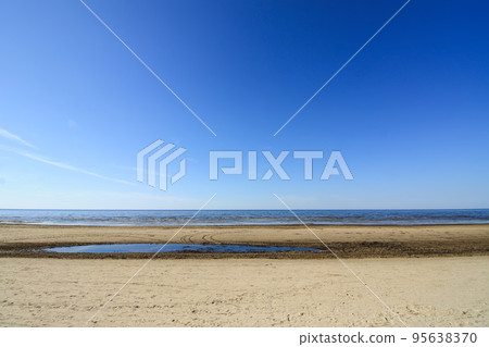 Baltic sea in spring day. Sandy beach in Jurmala, Latvia, East Europe. Baltic sea in spring day. Sandy beach in Jurmala, Latvia, East Europe. 95638370