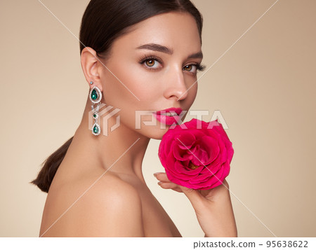 Beautiful young woman with a rose flower 95638622