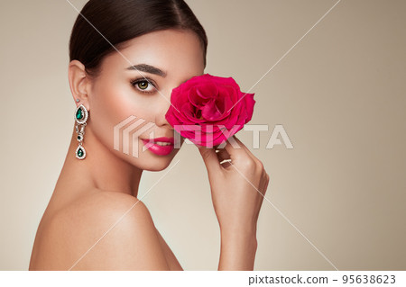 Beautiful young woman a rose flower 95638623