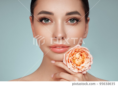 Beautiful young woman a rose flower Beautiful young woman a rose flower 95638635