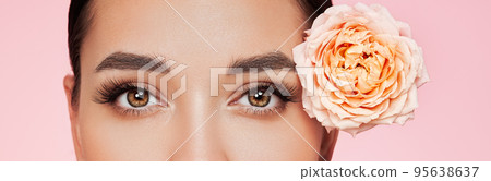 Beautiful young woman with a rose flower 95638637