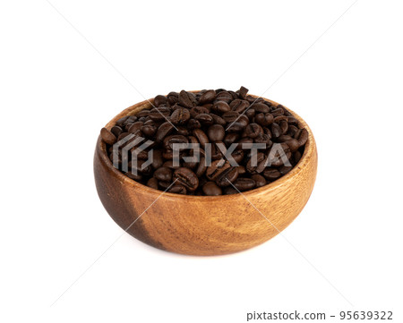 Freshly roasted coffee beans in a wooden bowl over white background. 95639322