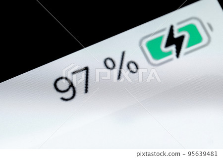 Smartphone charged battery level indicator - 97 percent: close up macro 95639481