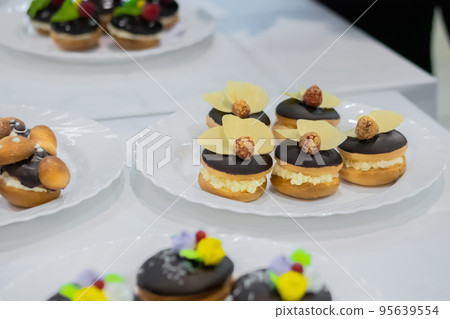 Fresh shortcrust tart cakes with cream and fruits on white plate for sale Fresh shortcrust tart cakes with cream and fruits on white plate for sale 95639554