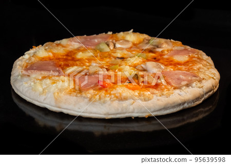Homemade pizza baking on tray in electric oven, black background Homemade pizza baking on tray in electric oven, black background 95639598