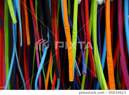 Colorful leather stripes on showcase in fashion shop Colorful leather stripes on showcase in fashion shop 95639823