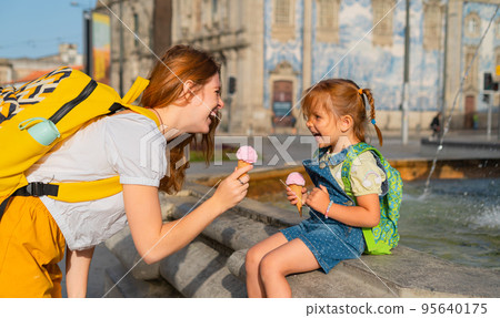 Mother and little daughter tourists with ice cream Mother and little daughter tourists with ice cream 95640175