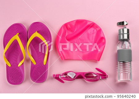 Flat lay composition with swimming accessories on pink background 95640240