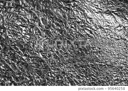 Crumpled silver foil as background, closeup view 95640258