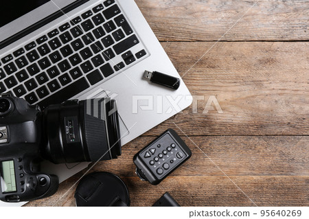 Flat lay composition with equipment for professional photographer on wooden table 95640269